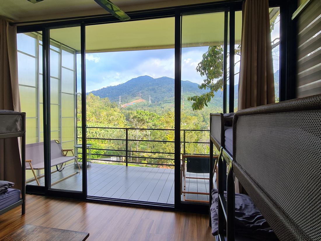 The view from between the bunks, through floor-to-ceiling glass doors to the balcony and mountains beyond